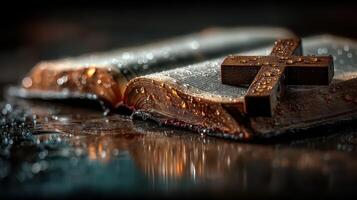 Religious scripture rests on wet surface with a wooden cross atop, showcasing themes of faith and reflection photo