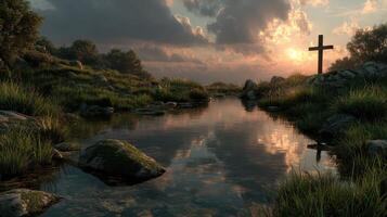 Sunset view over a tranquil stream with a cross in the background and lush greenery photo