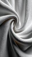 Soft white fabric in a swirling pattern highlights texture and light at close range photo