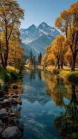 Vibrant autumn landscape with colorful trees and serene mountain reflections by a calm river photo
