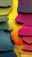 Vibrant layers of torn colored paper create a striking abstract composition with bold hues photo