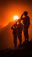 Soldiers saluting at sunset with mountains in the background during a moment of tribute photo