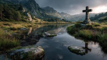 Misty landscape with a stone cross by a tranquil lake at twilight in the mountains photo
