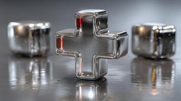 Shiny glass medical cross and cubes reflecting light on a polished surface in a modern setting photo
