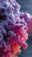 Colorful abstract swirl of purple and pink ink forming beautiful patterns in water photo