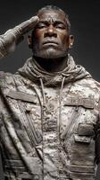 Saluting soldier in camouflage uniform with a determined expression in a dramatic light setting photo