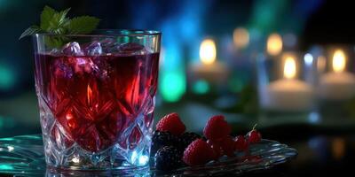 Refreshing berry cocktail served over ice with candles in the background during a cozy evening gathering photo