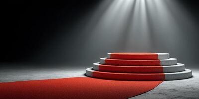 Red carpet leading to a circular stage illuminated by bright lights in a dimly lit space photo