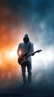 Unseen musician plays electric guitar amidst dynamic lighting and fog at a nighttime performance setting photo