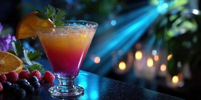 Colorful layered drink served in a clear glass with fresh fruit garnishes, showcased in a stylish bar with ambient lighting photo