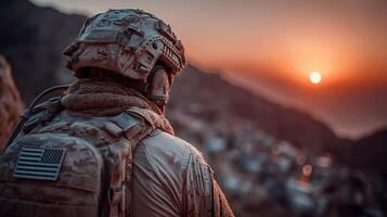 Soldier observing sunset over distant hills, reflecting on duty and sacrifice near military base photo