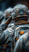 Soldiers salute in snowy environment during a military training exercise in winter conditions in the mountains photo