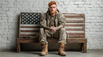 Veteran poses on rustic bench featuring American flag in urban setting with a serious expression photo