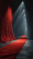 Red carpet leads to illuminated curtains in dark ambiance creating a dramatic entrance for an event or performance photo