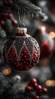 Beautiful red and black ornament hangs on a Christmas tree, surrounded by warm lights and festive decorations photo