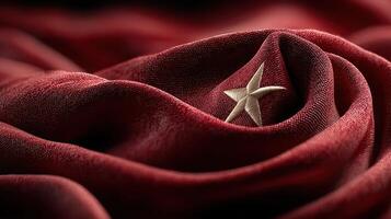 Red fabric with a star emblem symbolizes national pride and identity, showcasing intricate texture and deep color photo