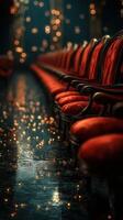 Elegant red chairs lining a dimly lit venue with glimmering lights reflecting on the floor photo