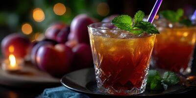 Refreshing sweet tea served in a glass with ice and mint leaves alongside ripe peaches photo