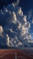 Dramatic clouds hover over an empty track as runners prepare for a race at sunset photo