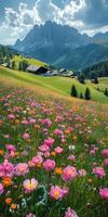 Colorful wildflowers bloom in a lush valley with towering mountains and a quaint village under a partly cloudy sky photo