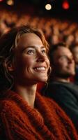 Audience members enjoy a captivating performance in a vibrant theater filled with excitement and anticipation photo