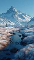Majestic snow-covered mountains reflect in tranquil stream at dawn photo