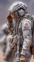 Soldier salutes while wearing advanced tactical gear during a desert operation on a clear day in the afternoon photo