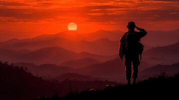 Soldier saluting at sunset overlooking mountain landscape in serene moment of reflection and respect photo
