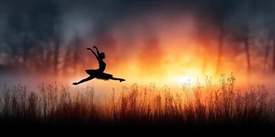 Ballerina leaps gracefully against a stunning sunset backdrop near a field of tall grass during twilight photo