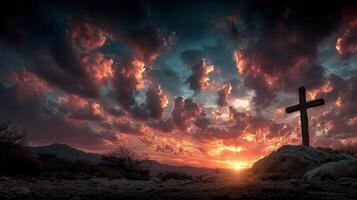 Majestic sunset behind a cross on a rocky landscape with dramatic clouds in the evening sky photo