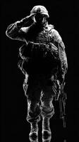 Silhouette of a soldier saluting in a dark environment with a rifle photo