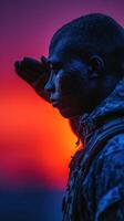 Soldier saluting at sunset with a dramatic sky background in a moment of respect and reflection photo