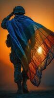 Soldier saluting at sunset wrapped in a colorful blanket captures the essence of bravery and resilience in a military setting photo