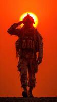Soldier saluting against dramatic sunset backdrop on military mission photo