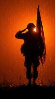 Soldier saluting in the rain with an American flag against a dramatic orange backdrop photo