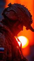 Soldier at sunset reflects on duty and service during a quiet moment in the field photo