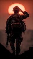 Soldier saluting during sunset in a military setting showcasing patriotism and bravery photo