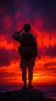 Soldier saluting against a vibrant sunset backdrop near the ocean photo