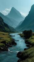 Mountain river flowing through a green valley surrounded by majestic peaks in the early morning light photo