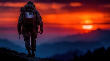 Soldier walking toward sunset with American flag on backpack in mountainous landscape photo