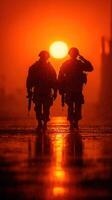 Soldiers salute as the sun sets over the horizon during a mission at dusk in an urban environment photo