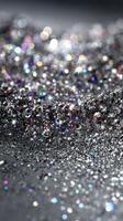 Sparkling silver glitter creates a mesmerizing surface filled with vibrant colors and reflections in a bright setting photo