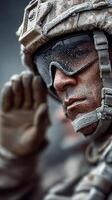 Soldier saluting with determination in a dusty environment during a military operation in a rugged terrain photo