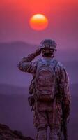 Soldier salutes at sunset over a mountain landscape in a moment of reflection and honor during a military operation photo