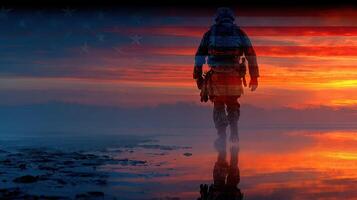 Soldier walking along a reflective shoreline at sunset with an American flag overlaying the background photo