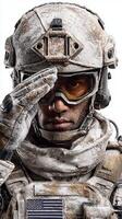 Soldier saluting in snowy combat gear while prepared for a mission in a cold environment photo
