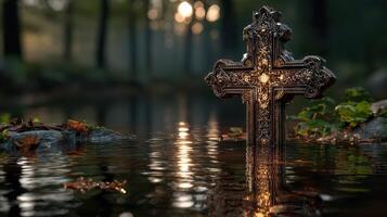 Ornate cross illuminated in calm water surrounded by trees at dusk in a serene forest setting photo