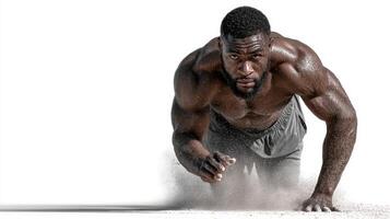 Muscular athlete training intensely on sandy surface during daylight hours photo
