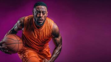 Intense basketball player dribbling towards the basket in vibrant orange uniform during a night game photo