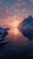 Sunset reflections over a tranquil river surrounded by snow-capped mountains in a serene winter landscape photo